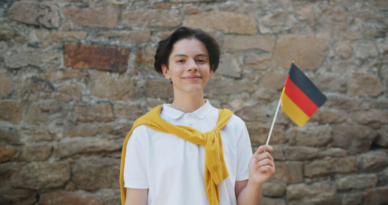 Young Boy Waiving with German Flag